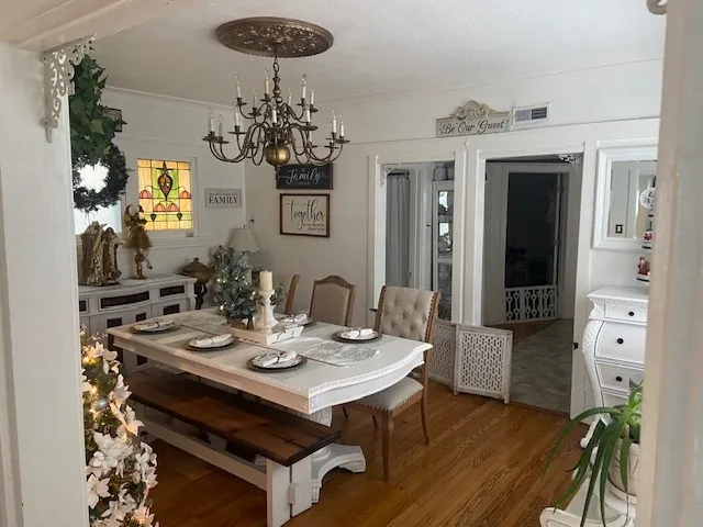 a view of a dining room with furniture and chandelier