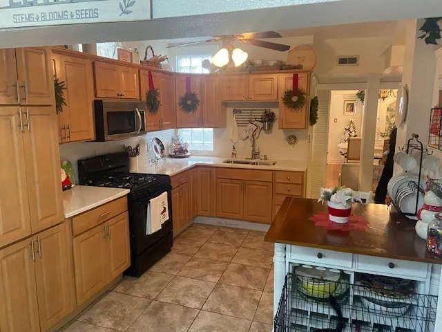 a kitchen with stainless steel appliances a sink stove and refrigerator