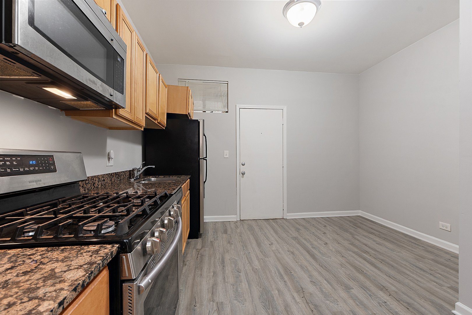 5150 South King Drive, Unit 2A Chicago, IL 60615 - Photo 14 of 22 a kitchen with wooden floors and a stove