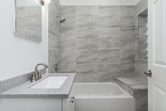 a bathroom with a sink and mirror