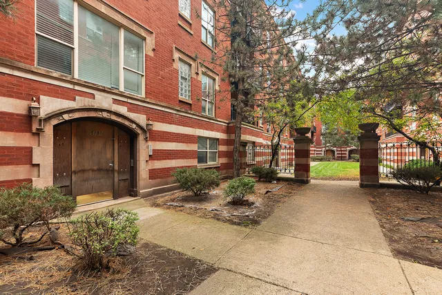 a yellow building with trees in front of it