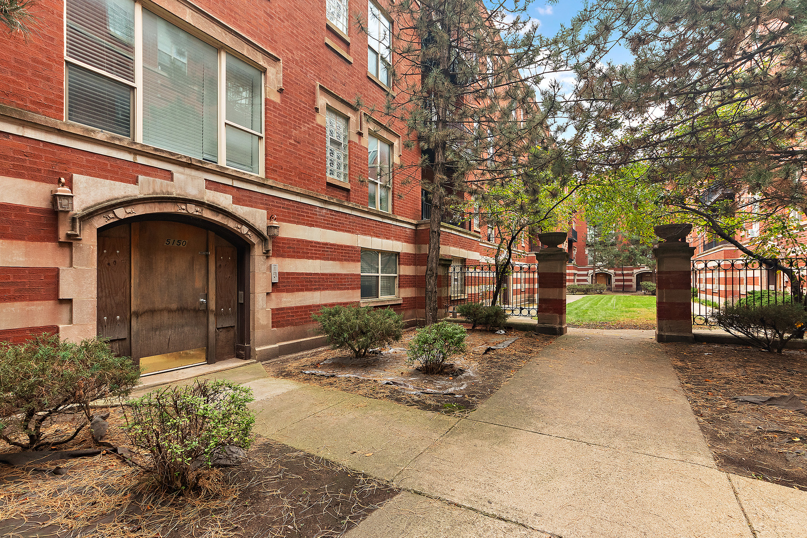 5150 South King Drive, Unit 2A Chicago, IL 60615 - Photo 4 of 22 a yellow building with trees in front of it