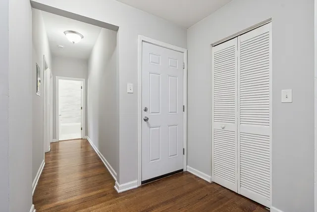 a view of a hallway with wooden floor