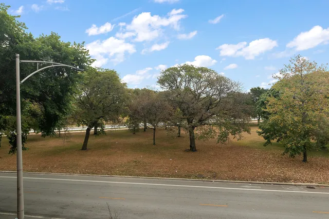 a view of a yard with basketball court