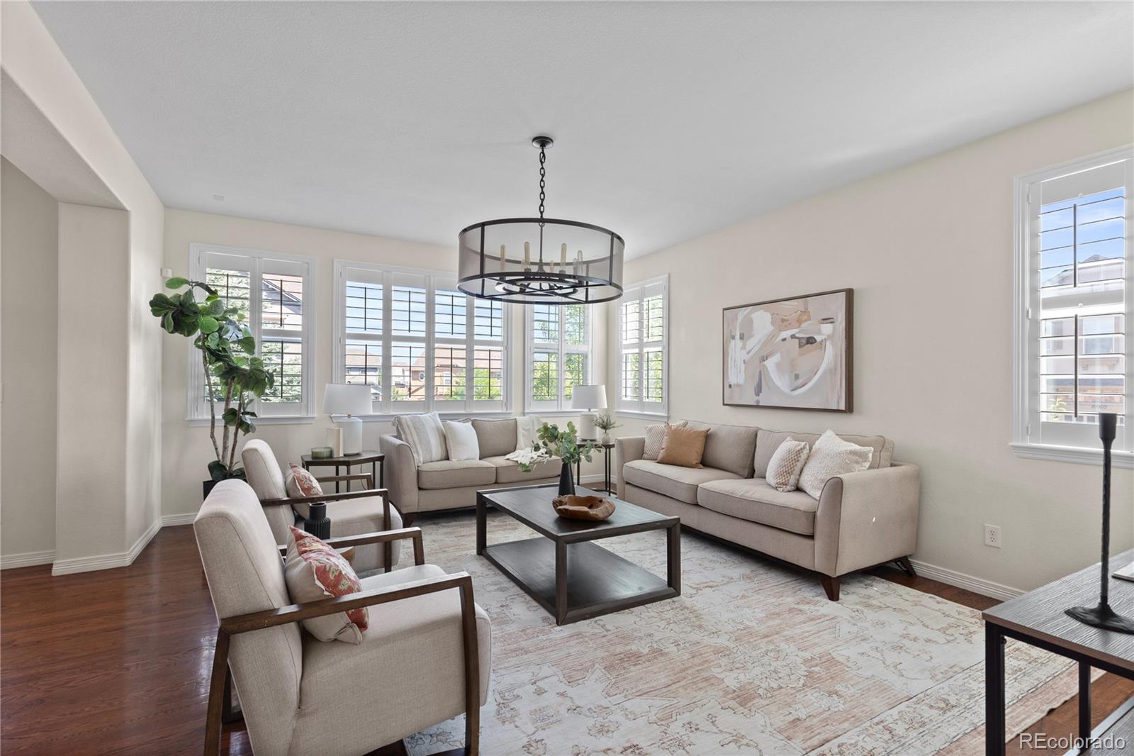 10840 Valleybrook Circle Highlands Ranch, CO 80130 - Photo 19 of 49 a living room with furniture chandelier and a window