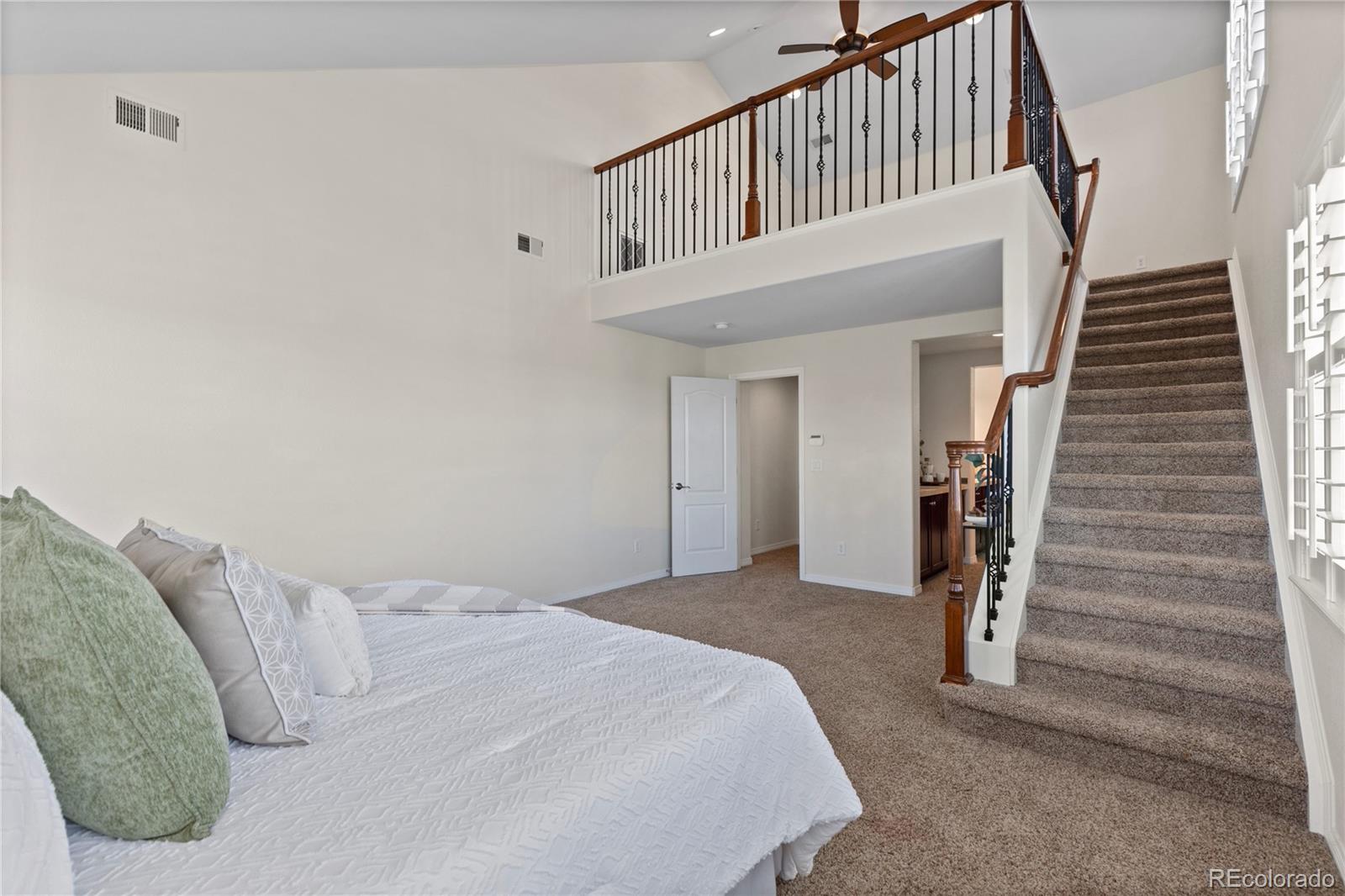 10840 Valleybrook Circle Highlands Ranch, CO 80130 - Photo 29 of 49 a view of a bedroom with wooden floor and stairs