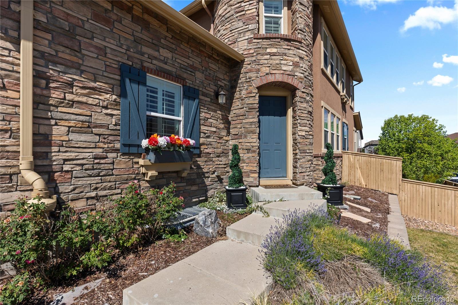 10840 Valleybrook Circle Highlands Ranch, CO 80130 - Photo 3 of 49 a front view of a house with an outdoor space