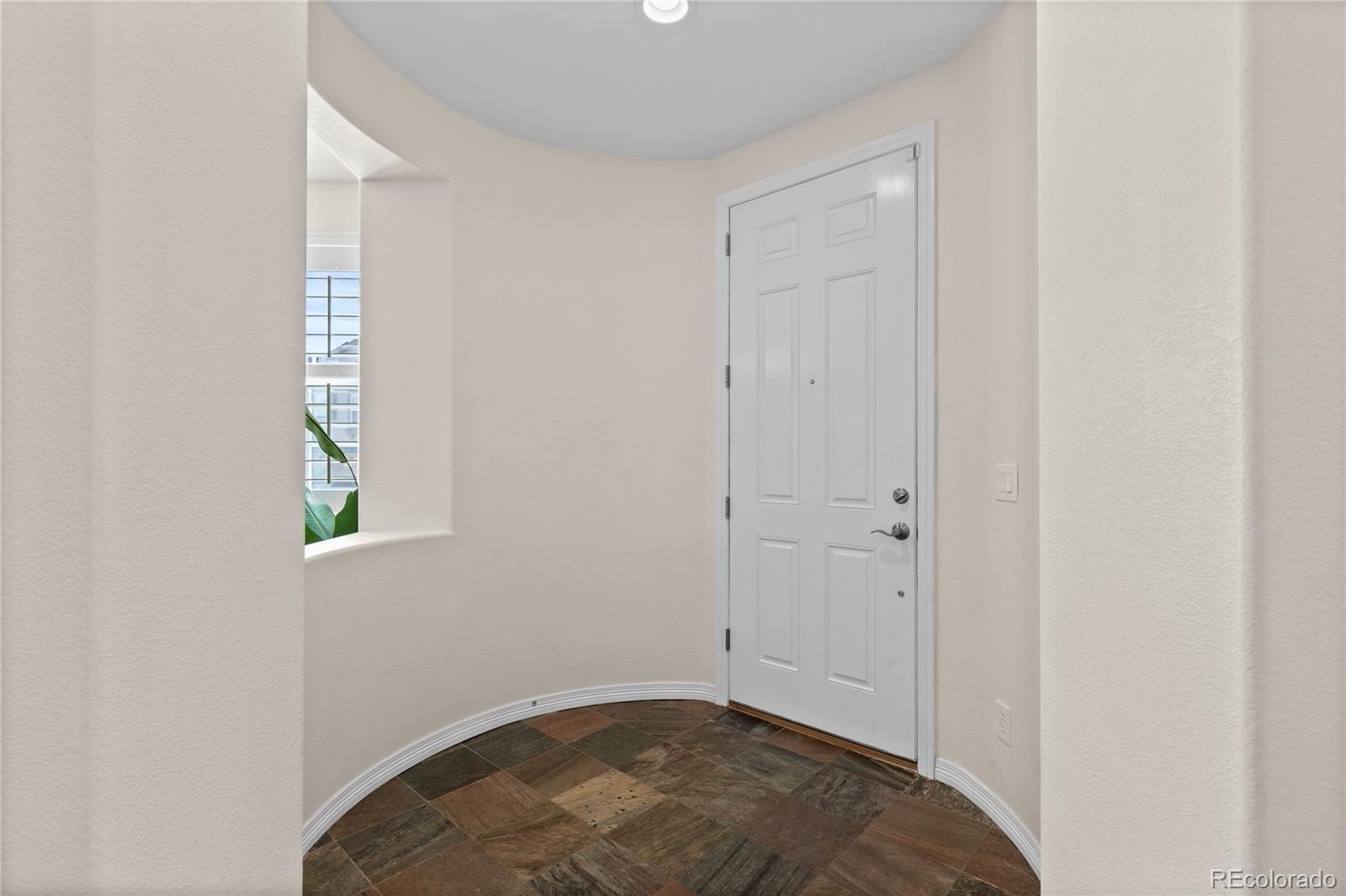 10840 Valleybrook Circle Highlands Ranch, CO 80130 - Photo 4 of 49 an empty room with windows