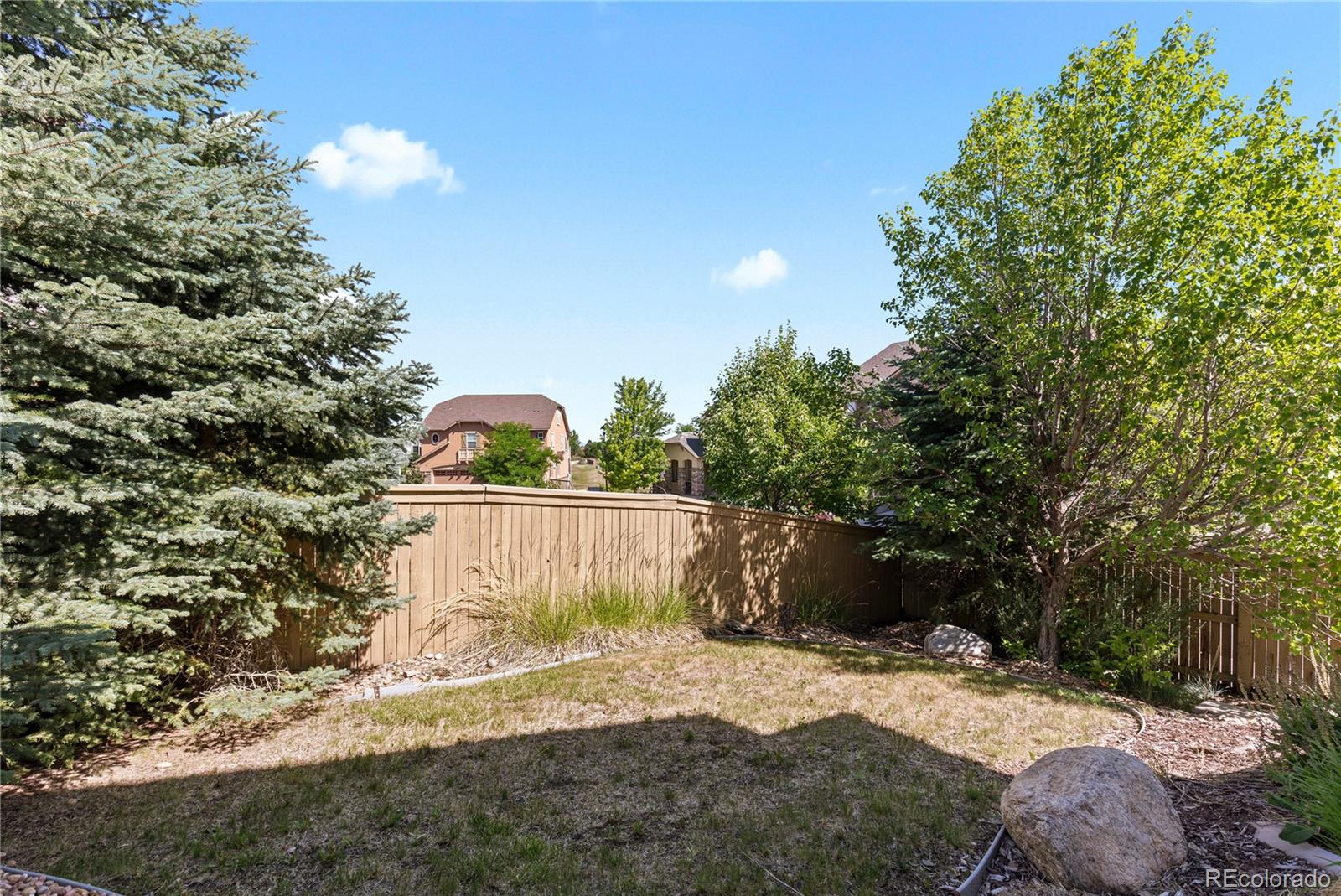 10840 Valleybrook Circle Highlands Ranch, CO 80130 - Photo 46 of 49 a view of a yard along with trees