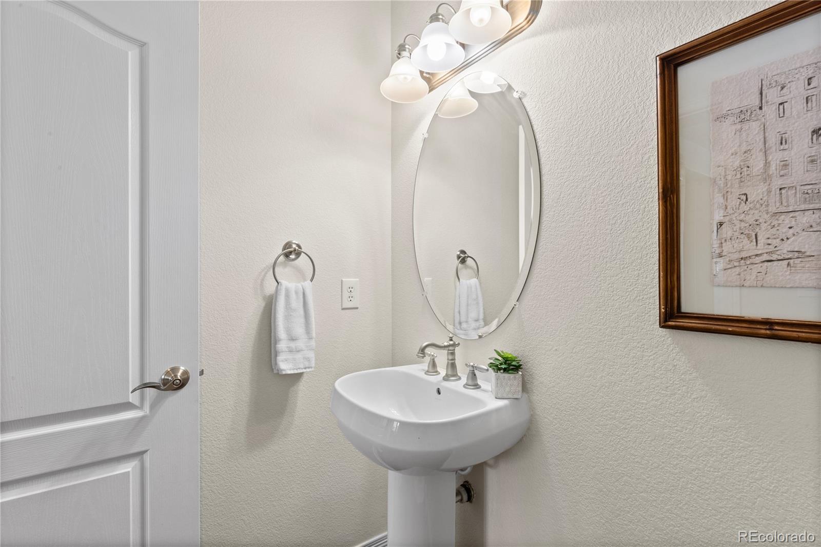 10840 Valleybrook Circle Highlands Ranch, CO 80130 - Photo 8 of 49 a bathroom with a sink and a mirror
