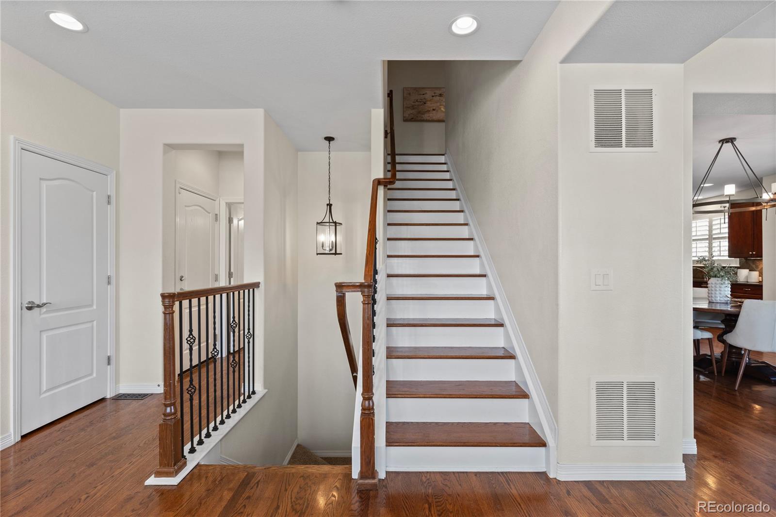 10840 Valleybrook Circle Highlands Ranch, CO 80130 - Photo 9 of 49 a view of a hallway with wooden floor and entryway