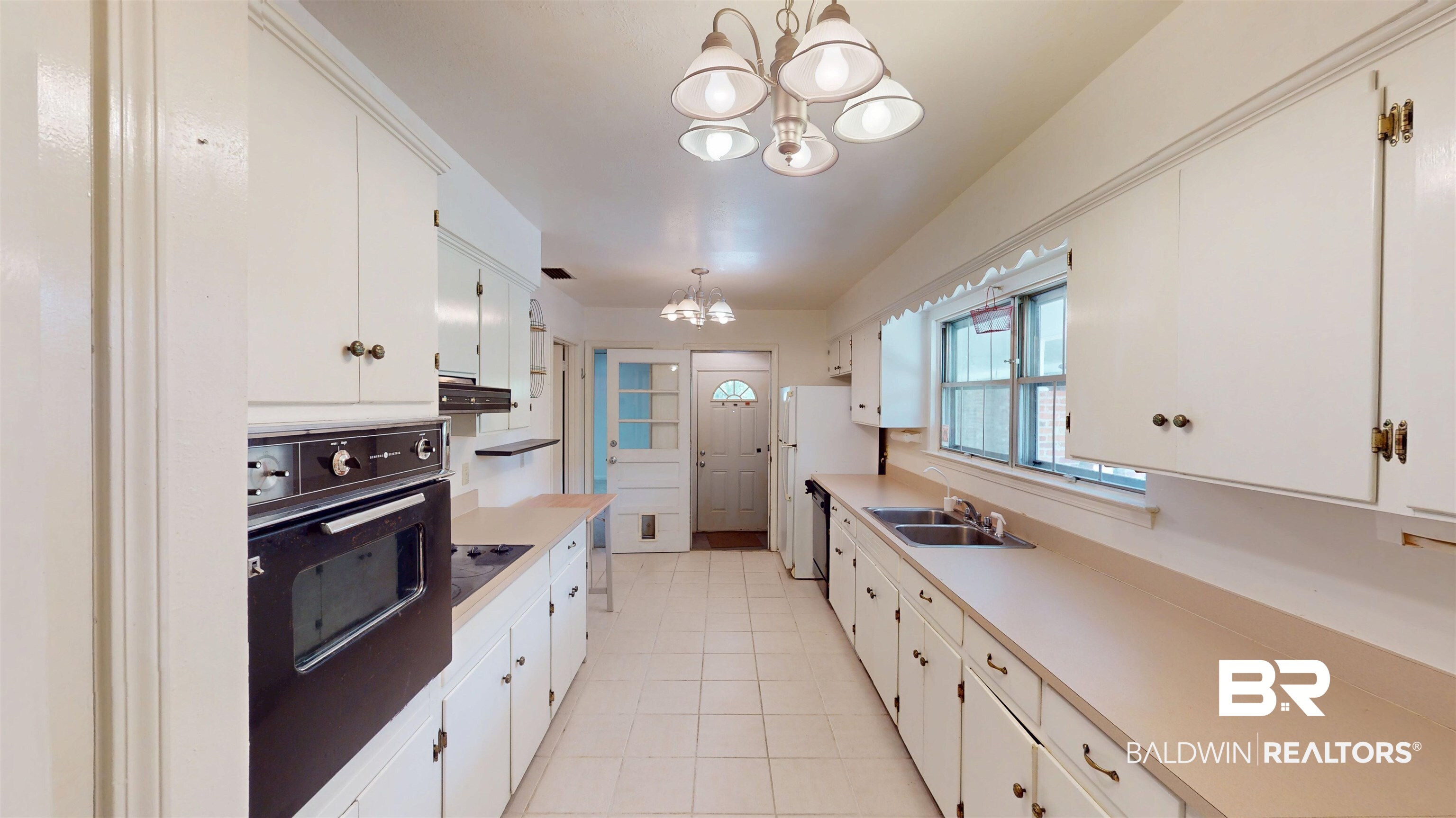 1075 Zurich Street Mobile, AL 36608 - Photo 17 of 35 Kitchen with hanging lights, black appliances, and white cabinets
