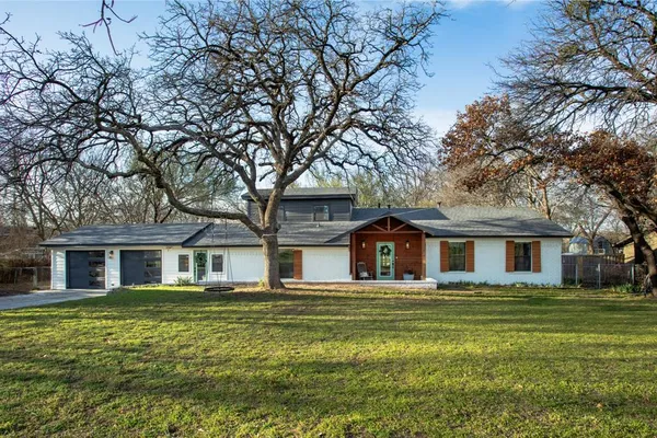 a front view of house with yard and green space