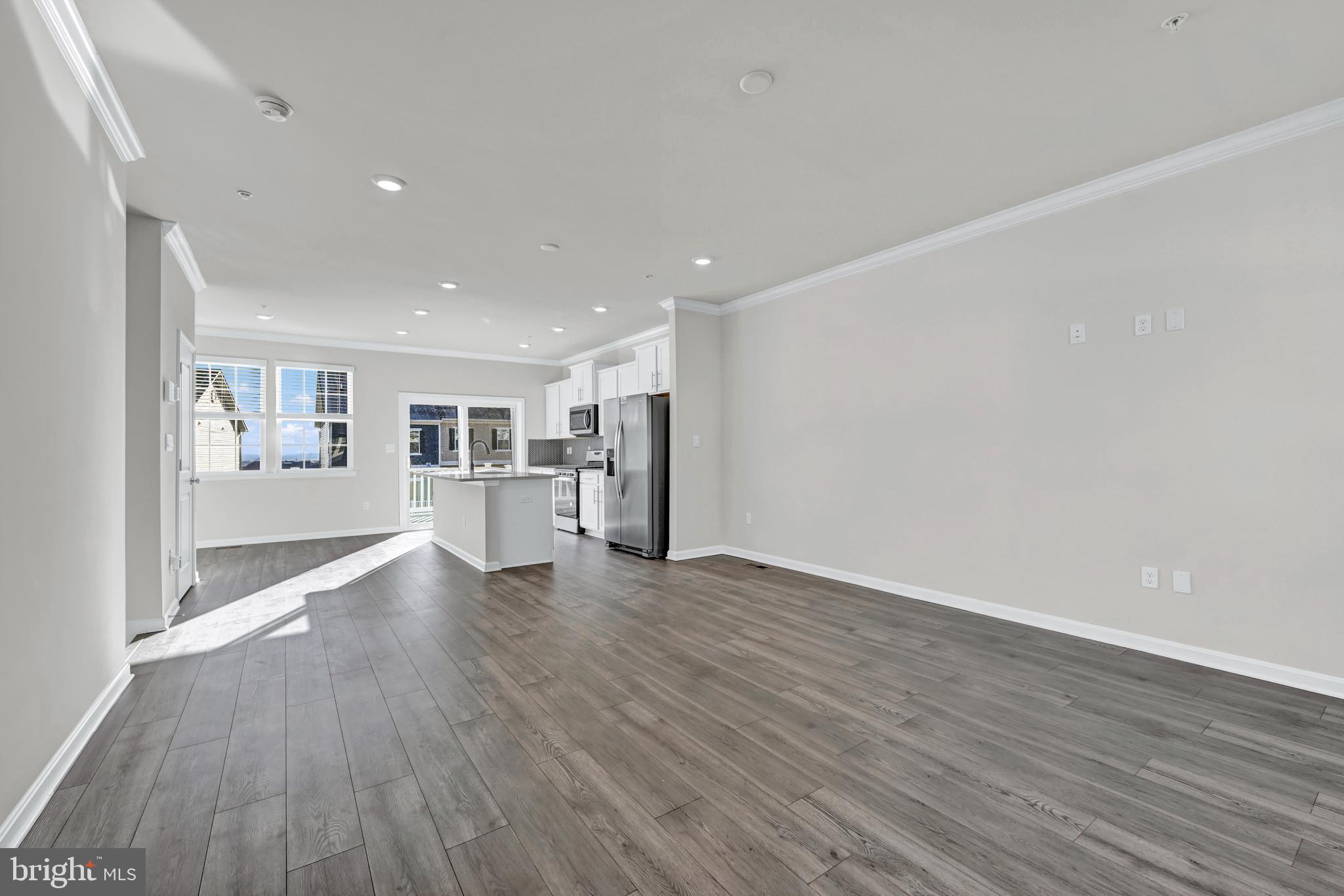 5015 Silver Oak Drive Rosedale, MD 21237 - Photo 8 of 34 a view of a big room with wooden floor and windows