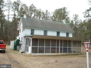 a house with trees in the background