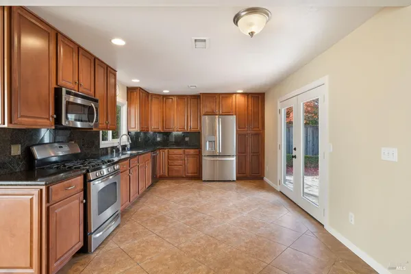 a large kitchen with stainless steel appliances lots of counter top space