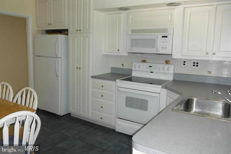 8400 Allison Lane Rosedale, MD 21237 - Photo 15 of 23 a kitchen with white cabinets and sink