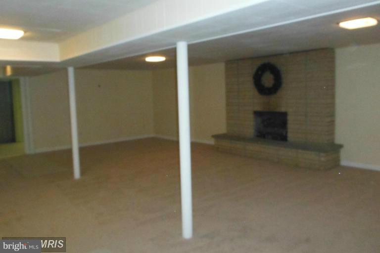 8400 Allison Lane Rosedale, MD 21237 - Photo 21 of 23 an empty room with mirror and a bathroom