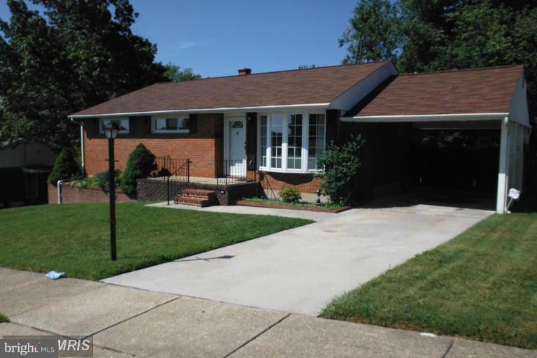 8400 Allison Lane Rosedale, MD 21237 - Photo 5 of 23 a front view of a house with a garden and yard