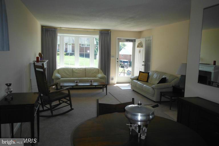 8400 Allison Lane Rosedale, MD 21237 - Photo 7 of 23 a living room with furniture and a floor to ceiling window