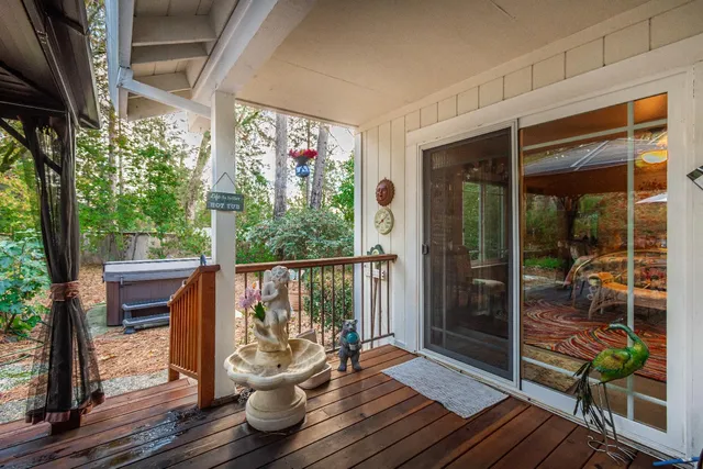 a view of a balcony with chair and wooden floor