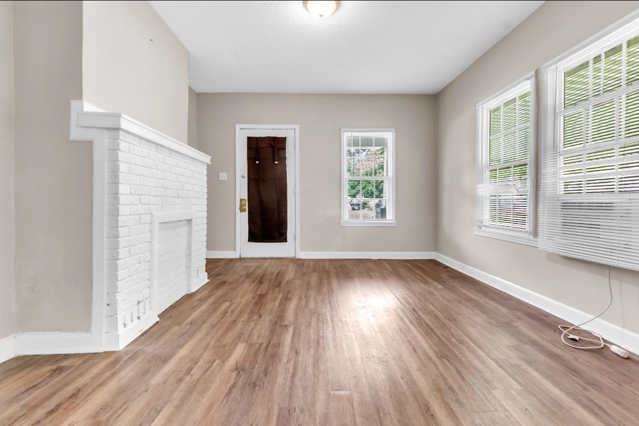 1148 Rozelle Street Memphis, TN 38106 - Photo 3 of 16 an empty room with wooden floor and windows