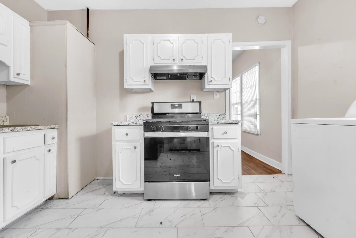 1148 Rozelle Street Memphis, TN 38106 - Photo 10 of 16 a kitchen with cabinets and a stove top oven