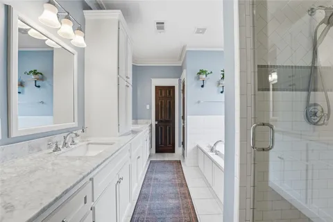 a bathroom with a tub a sink and a window