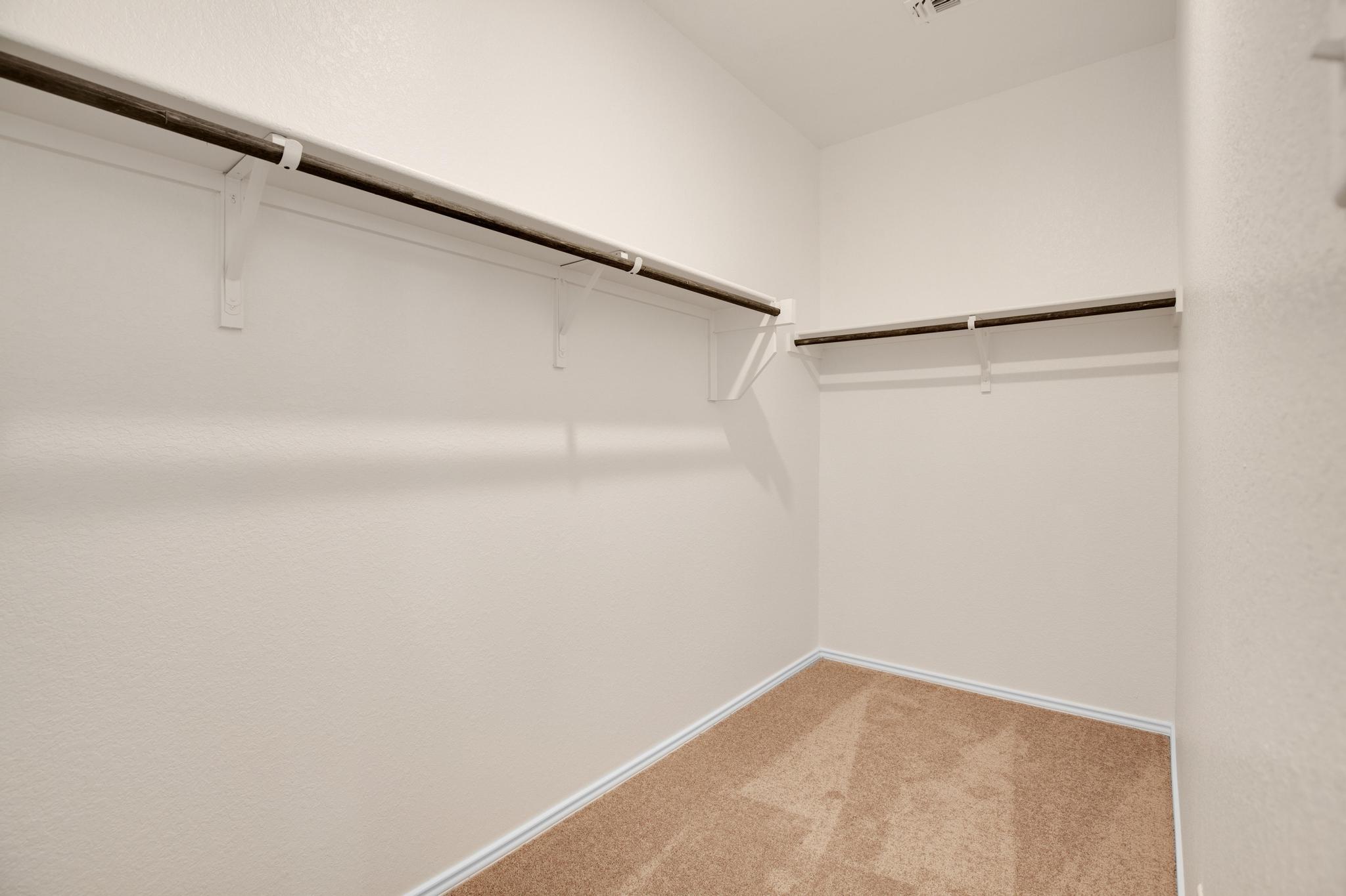 200 Janice Road Taylor, TX 76574 - Photo 12 of 25 Step into this organized walk-in closet featuring ample shelving and hanging space.