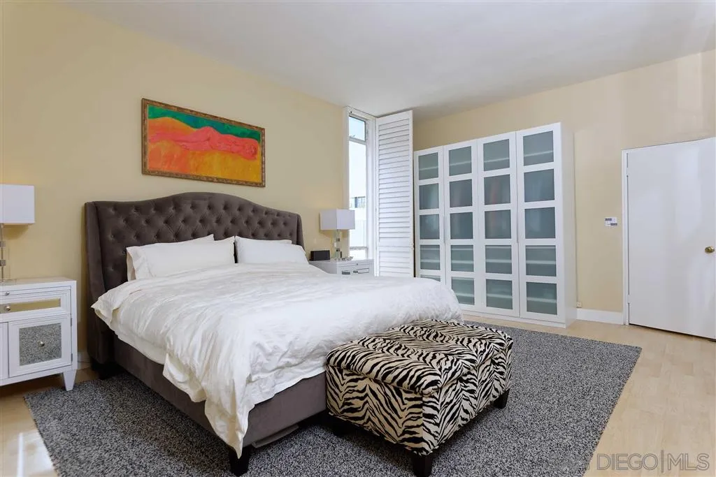 1228 Cave Street La Jolla, CA 92037 - Photo 12 of 22 a bedroom with a bed and a window