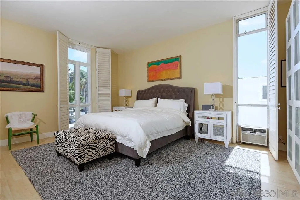 1228 Cave Street La Jolla, CA 92037 - Photo 13 of 22 a bedroom with a bed and dresser