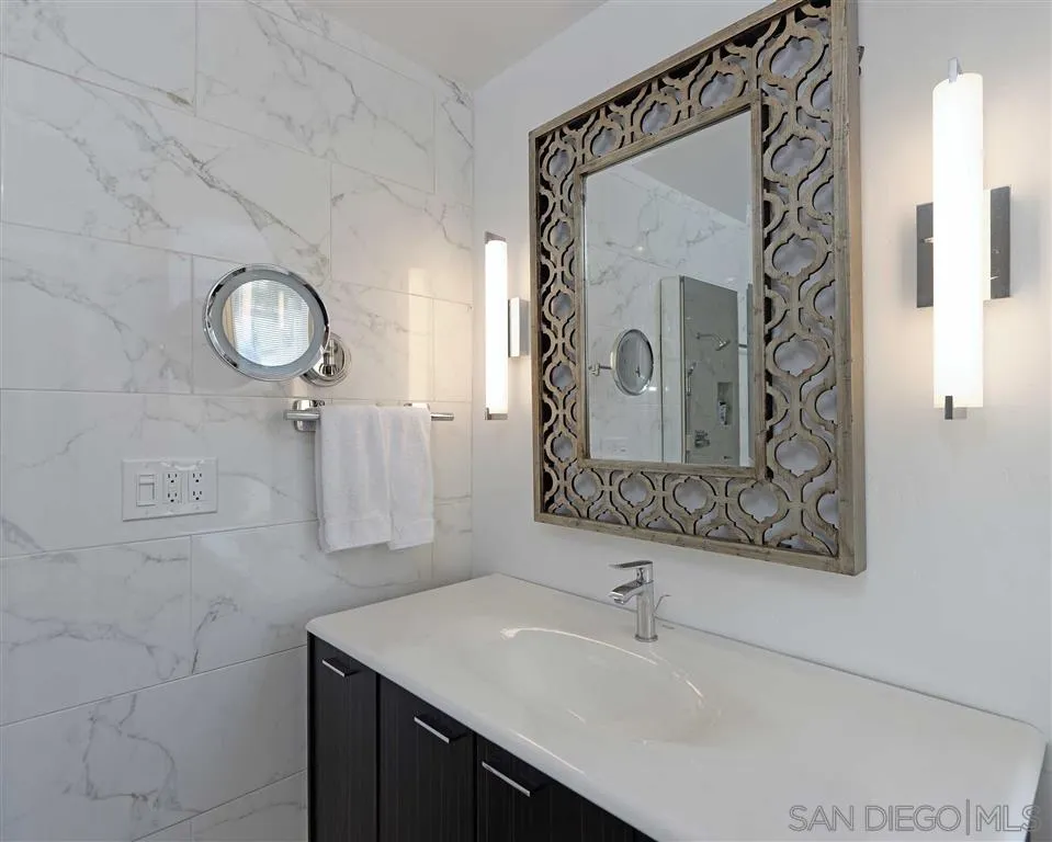 1228 Cave Street La Jolla, CA 92037 - Photo 15 of 22 a bathroom with a sink and a mirror