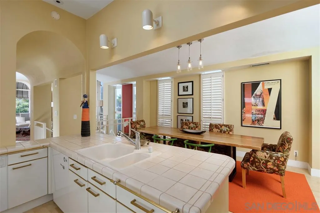 1228 Cave Street La Jolla, CA 92037 - Photo 5 of 22 a large living room with stainless steel appliances kitchen island granite countertop furniture and a kitchen view