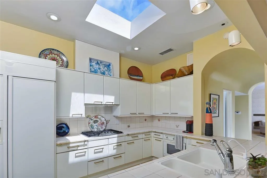 1228 Cave Street La Jolla, CA 92037 - Photo 6 of 22 a kitchen with a sink cabinets and window
