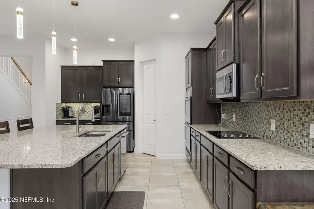a kitchen with granite countertop a sink and cabinets