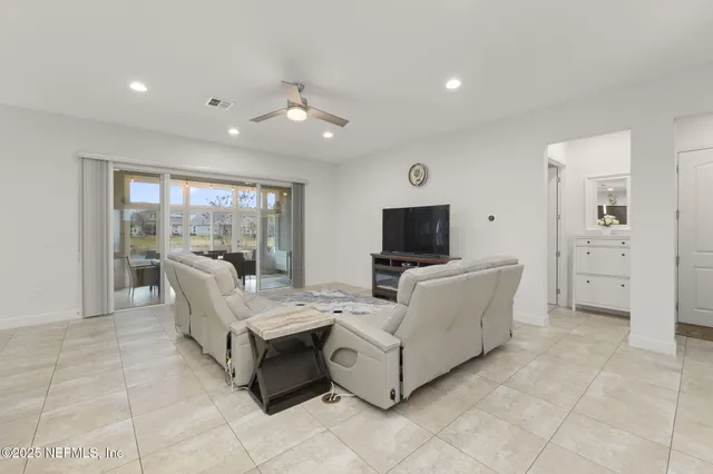 a living room with furniture and kitchen view
