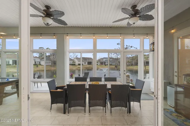 a view of a dining room with furniture a chandelier and wooden floor