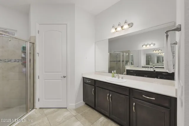 a bathroom with a granite countertop sink and vanity