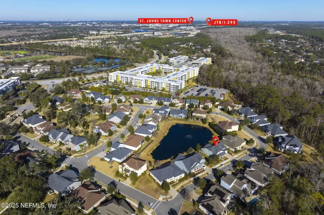an aerial view of residential houses with city view