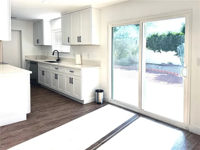 a kitchen with a window a sink and a stove
