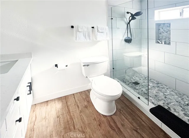 a bathroom with a toilet and a shower