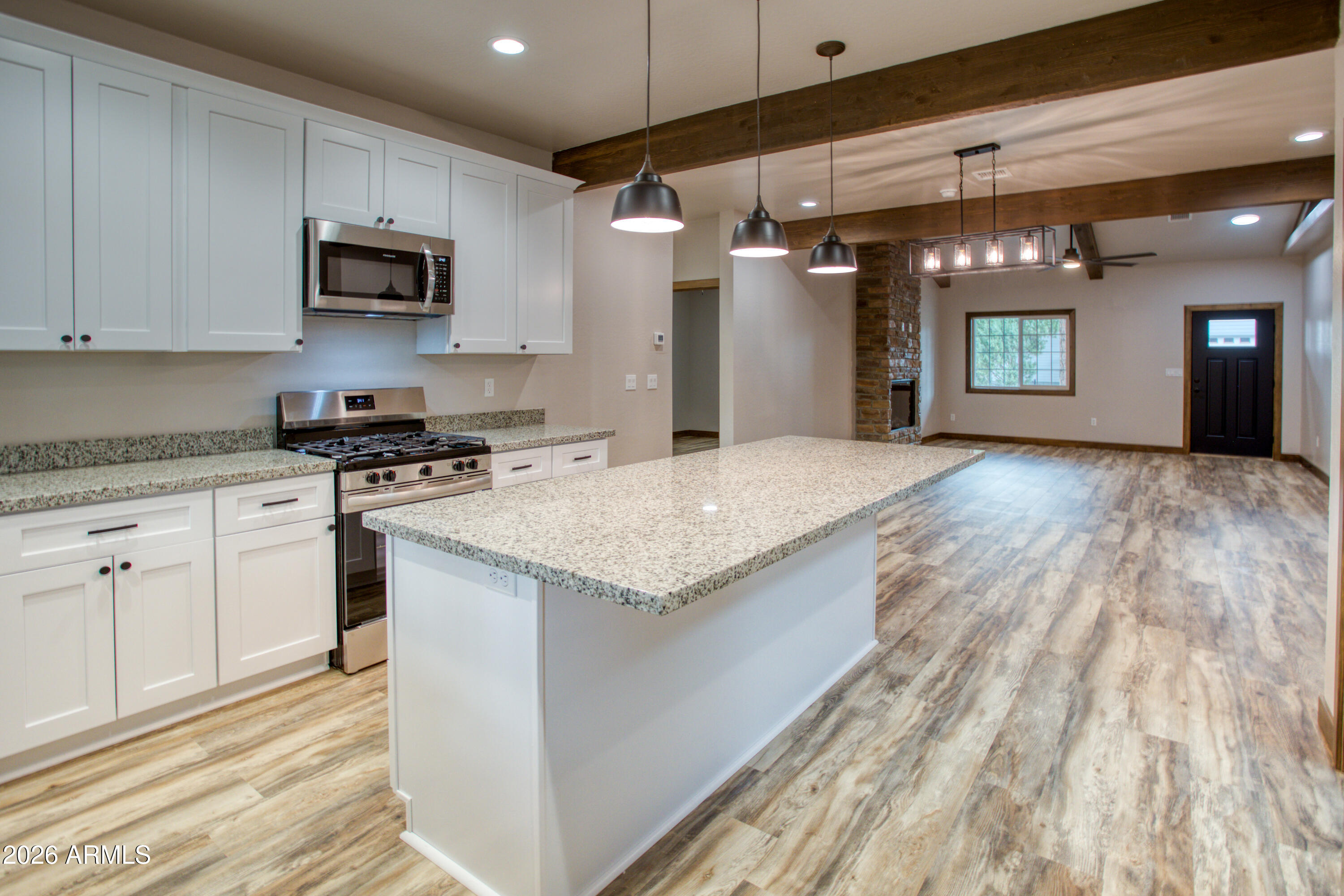 620 Campbell Lane Show Low, AZ 85901 - Photo 10 of 52 a kitchen with granite countertop a stove a sink and a refrigerator