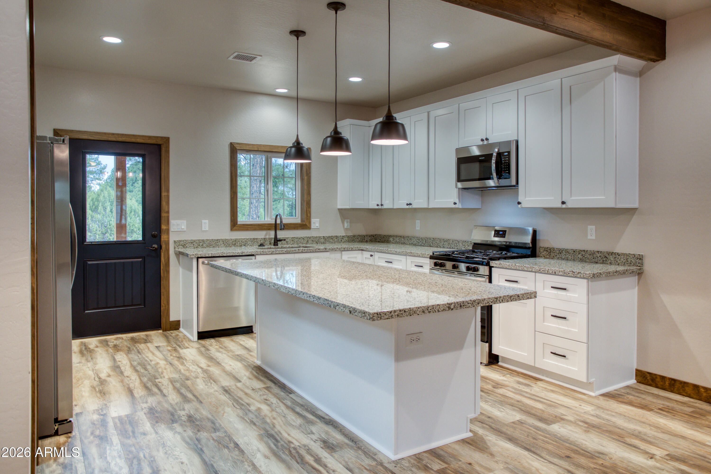 620 Campbell Lane Show Low, AZ 85901 - Photo 11 of 52 a kitchen with stainless steel appliances granite countertop a sink stove and refrigerator