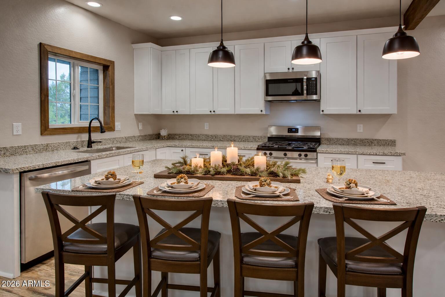 620 Campbell Lane Show Low, AZ 85901 - Photo 6 of 52 a kitchen with stainless steel appliances kitchen island a table and chairs in it
