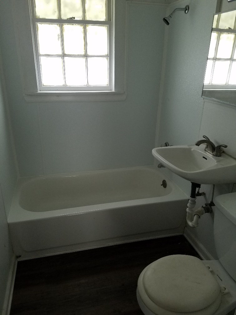 4023 6th Avenue Columbus, GA 31904 - Photo 3 of 9 a bathroom with a sink a toilet and bathtub