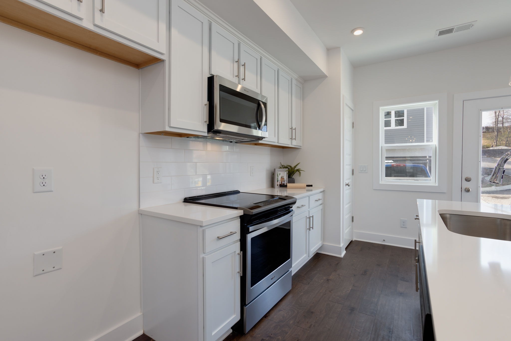 500 Creative Way, Unit 22 Madison, TN 37115 - Photo 17 of 21 a kitchen with stainless steel appliances white cabinets and a stove top oven