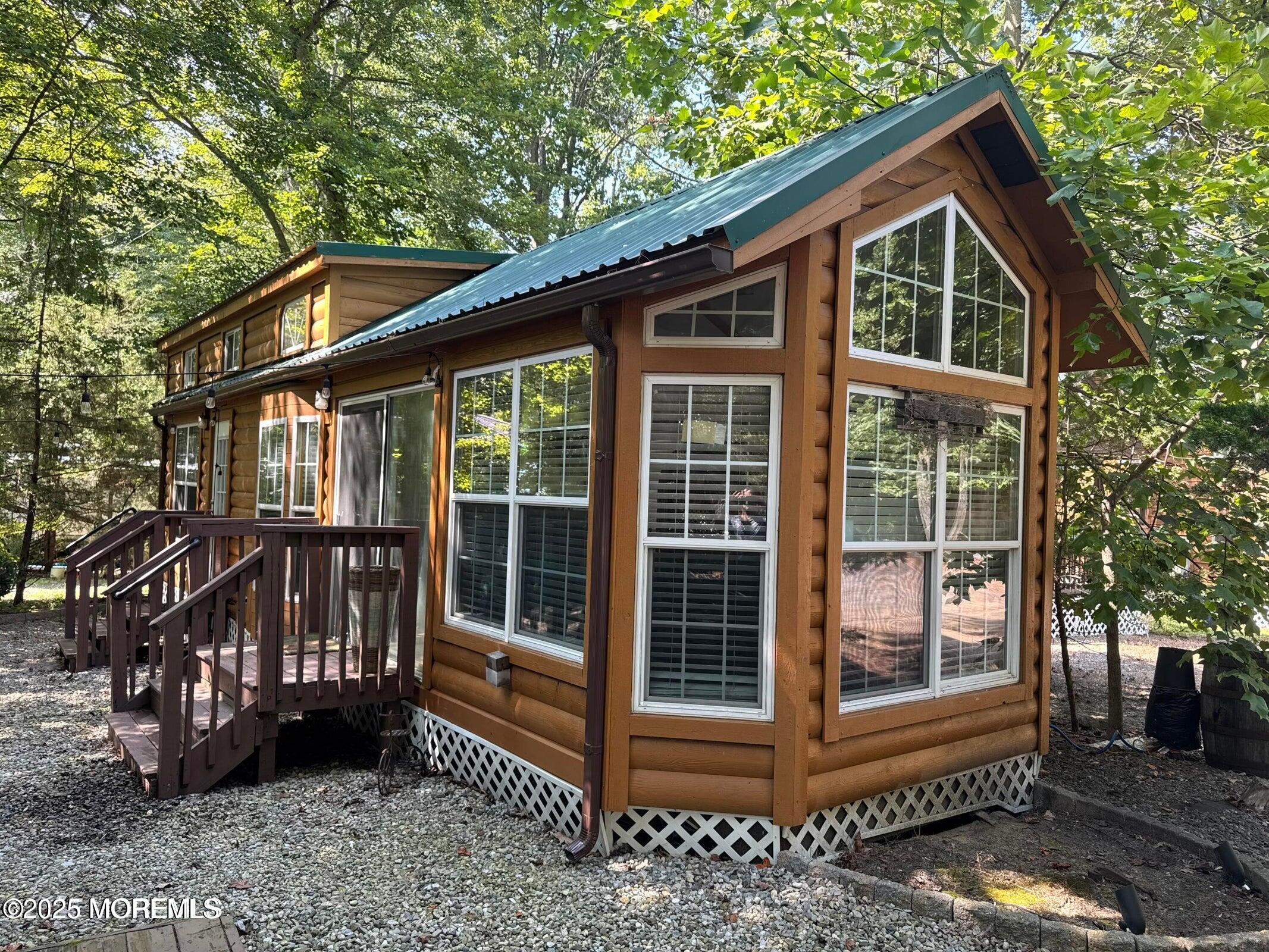 a view of a house with a window and wooden fence