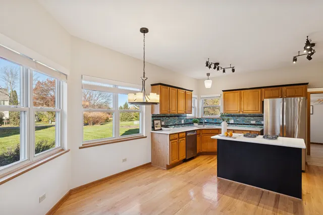 a kitchen with stainless steel appliances granite countertop a stove and a sink