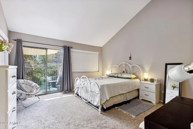 a bedroom with a bed and large window