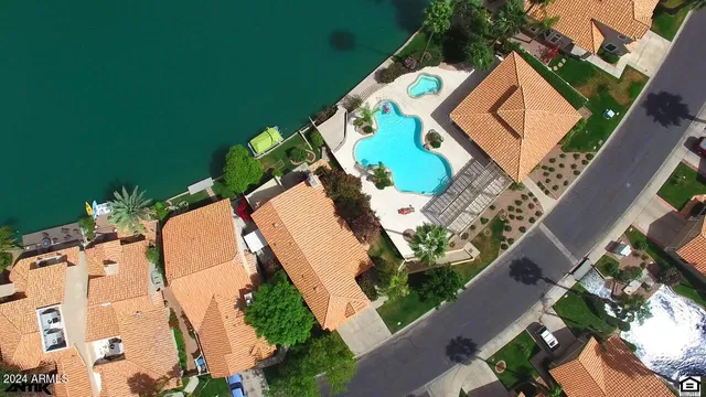 an aerial view of a house with a yard and trees